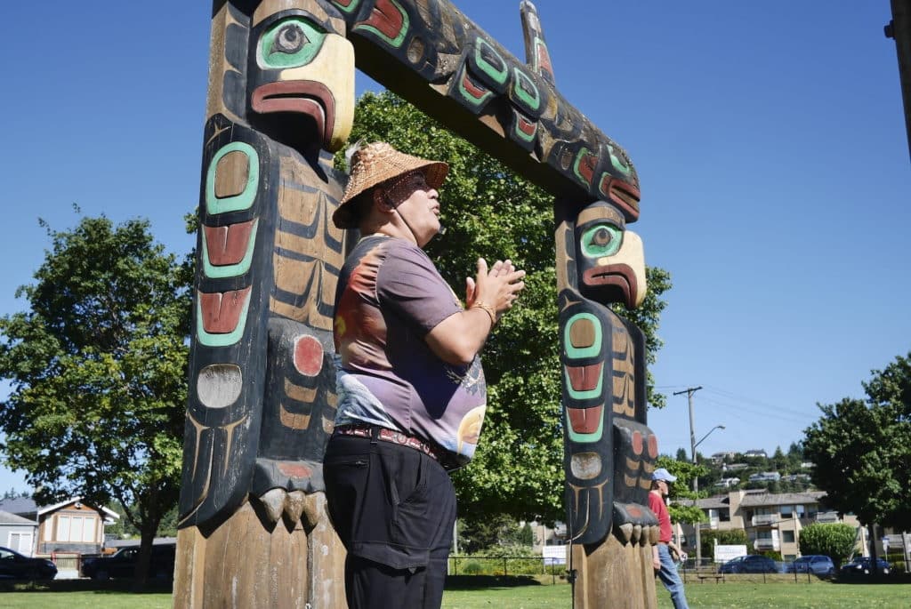 Snuneymuxw knowledge keeper Dave Spirit Wolf Bodaly stands in front of the welcome portal at the opening of the tour in Stiil'nup, Departure Bay.
