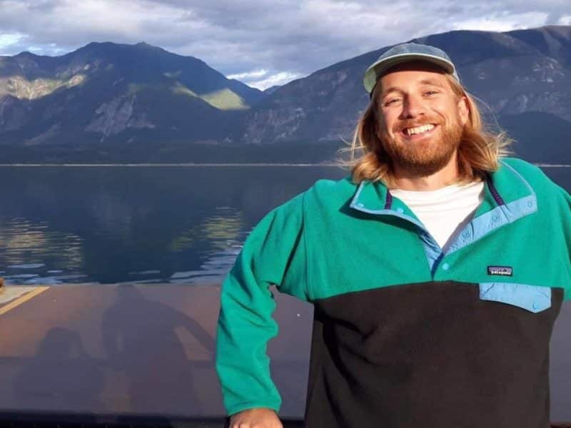 Joe Paris is pictured standing in front of a body of water.