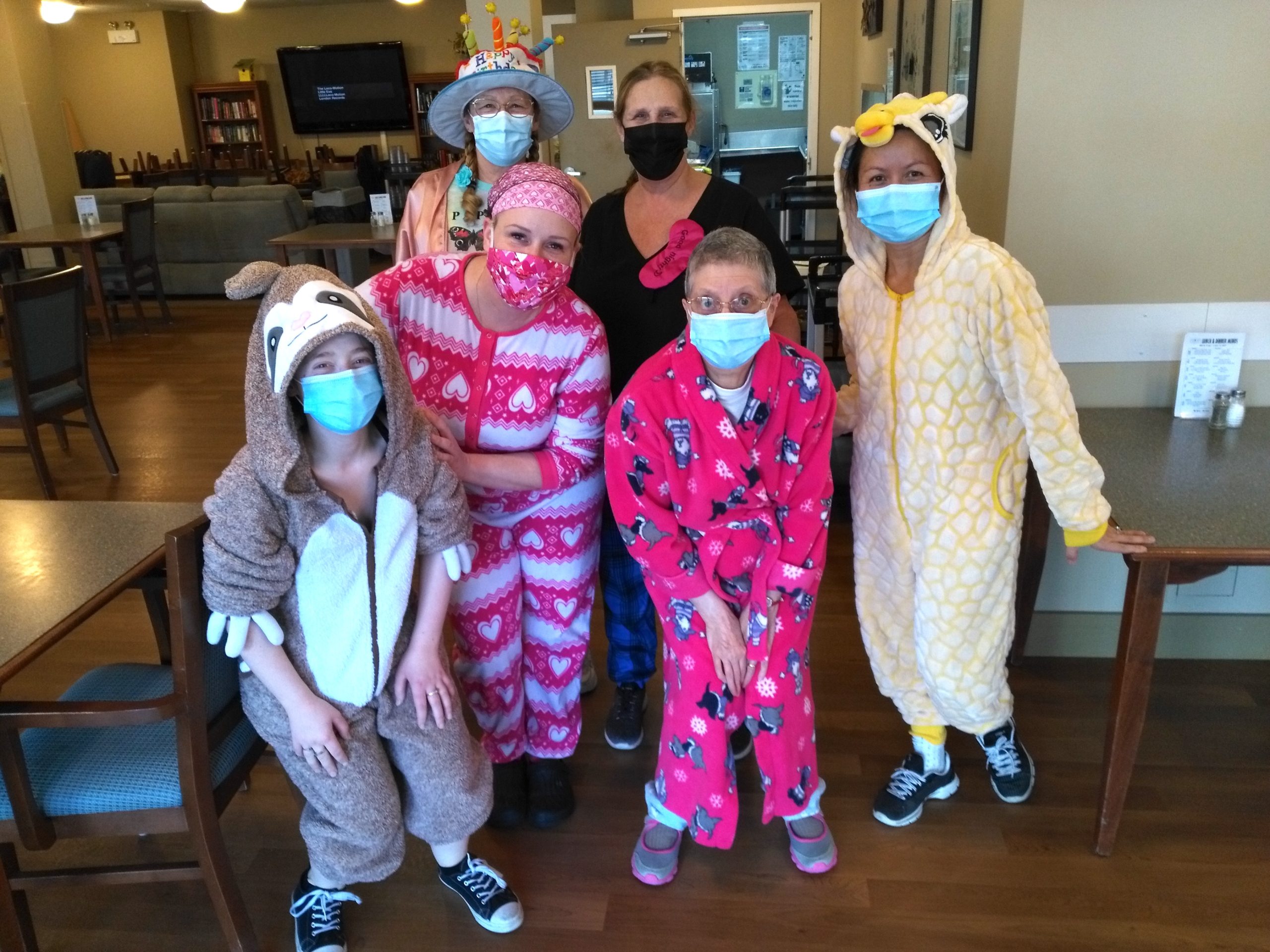 In January, Oak Tree Manor affordable seniors’ home staff and one resident dress up in bright coloured onesies some with bunny ears in the dining hall for pajama day.