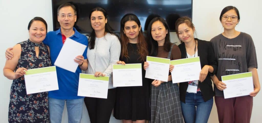 Graduates of NewToBC's Library Champions program stand with their certificates