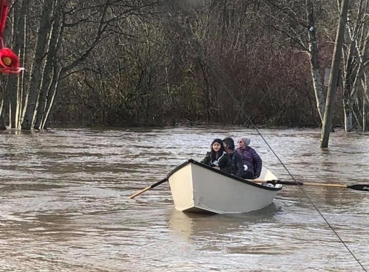 Darin George rows residents down Sahilton Road, which flooded as high as residents' front porches. (Courtesy Darin George)