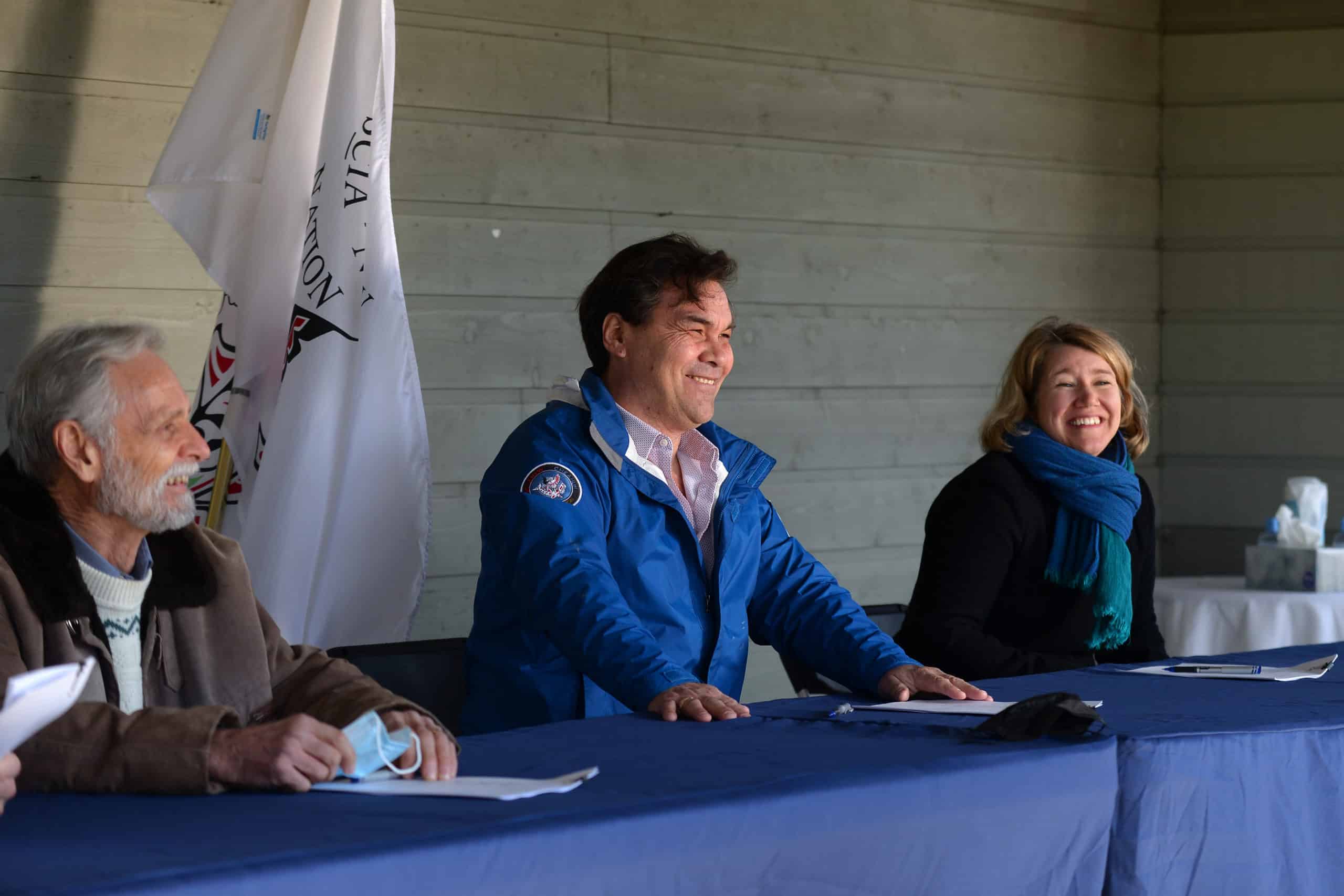 Metchosin Mayor John Ranns, SC’IA⁄NEW First Nation Chief Russ Chipps and Habitat Acquisition Trust executive director Katie Blake share a laugh as they prepare to sign a standstill agreement to consider a proposed Indigenous protected area at Mary Hill.