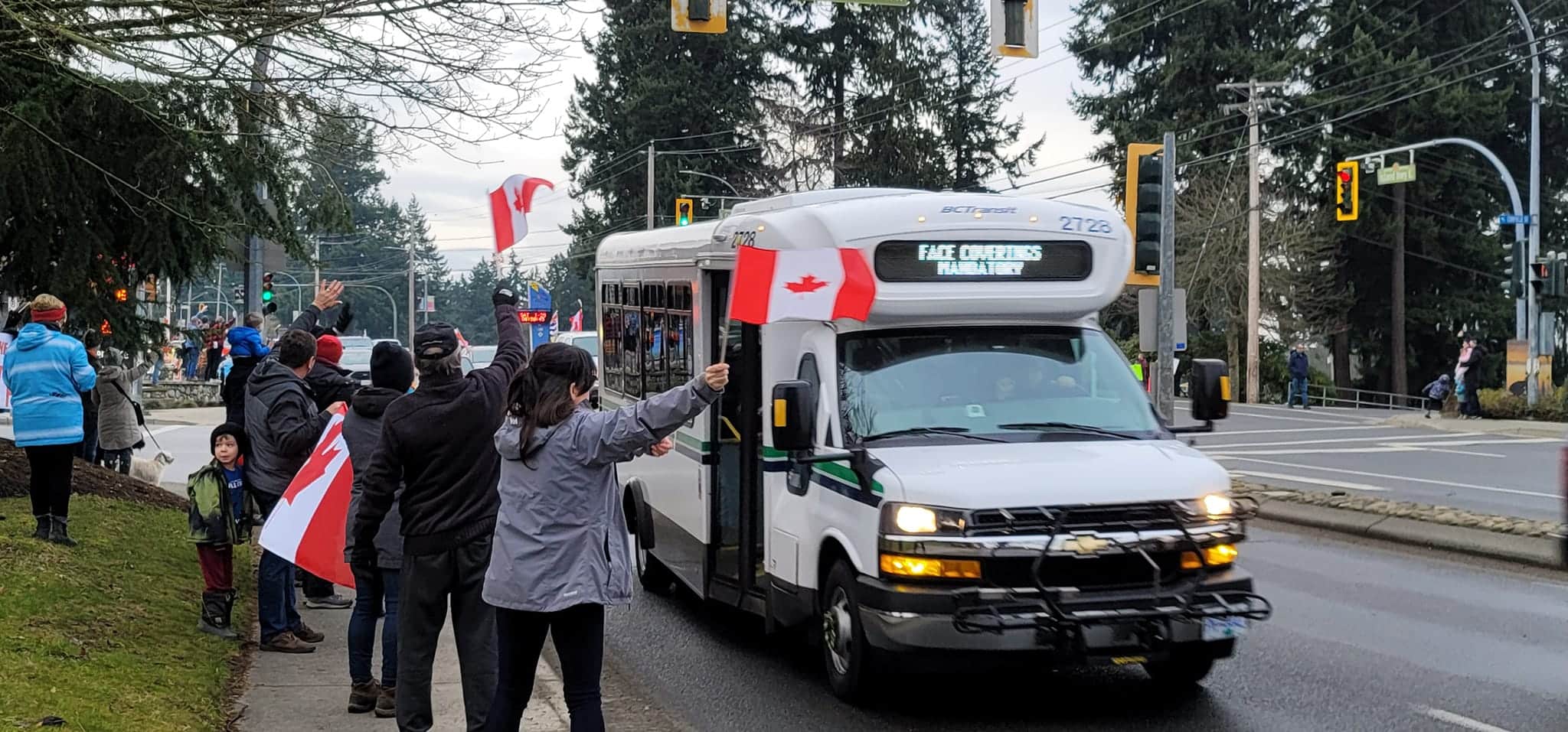 Protesters wave flags at a rally on Jan. 29 in Parksville, B.C. Photo courtesy of Deborah Vanderwolf