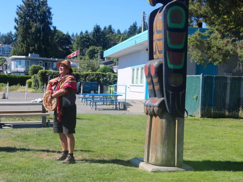 Dave Spirit Wolf Bodaly stands in front of the Stiil'nep Welcome Portal as he tells The Discourse readers the meaning of each figure.