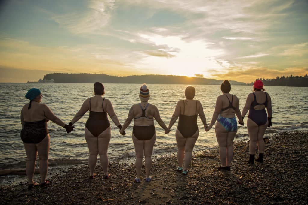 Cold water swimmers join hands before they brave the plunge at Departure Bay on Jan. 9.
