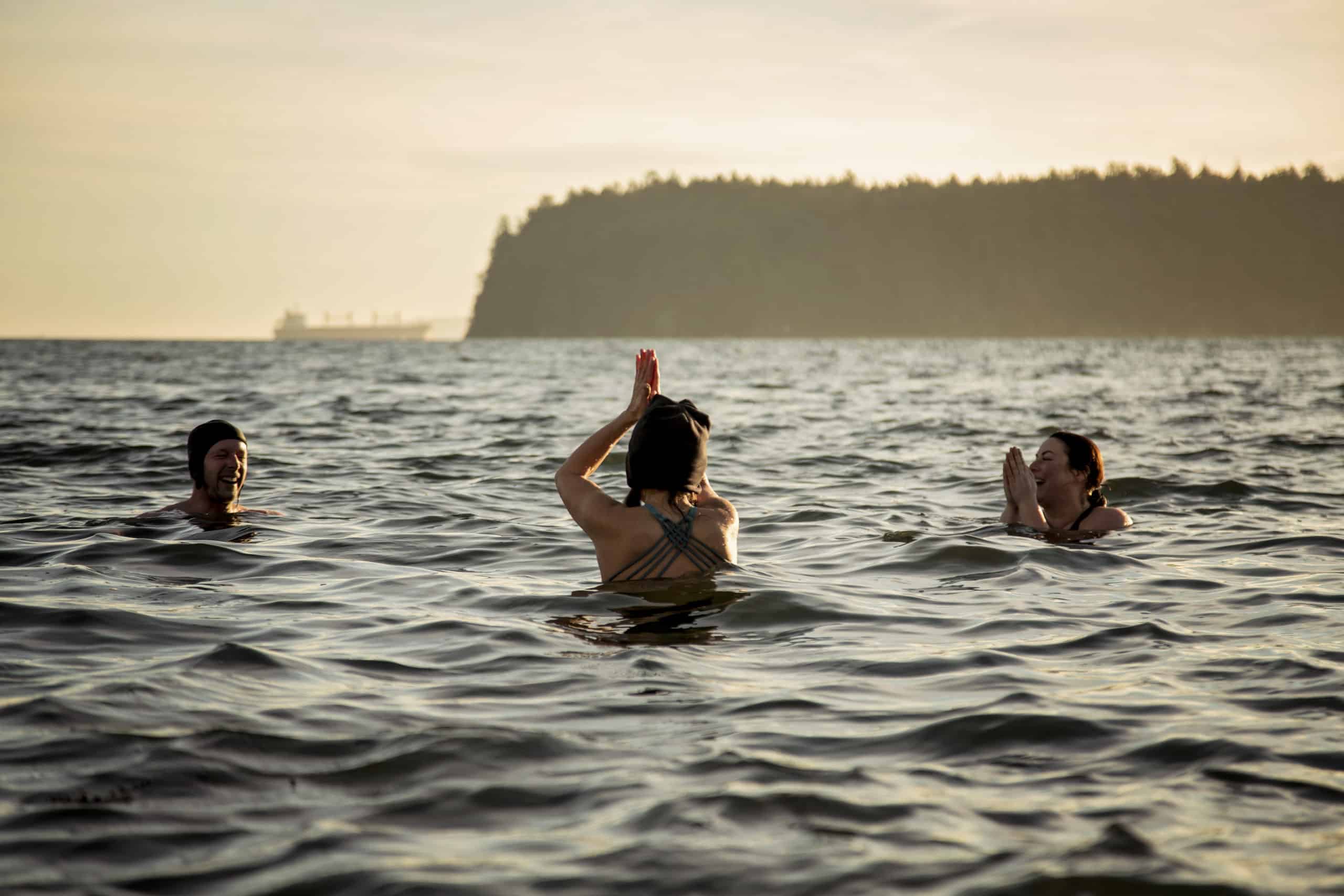In Departure Bay, locals raise their hands above water as they practice cold water swimming.
