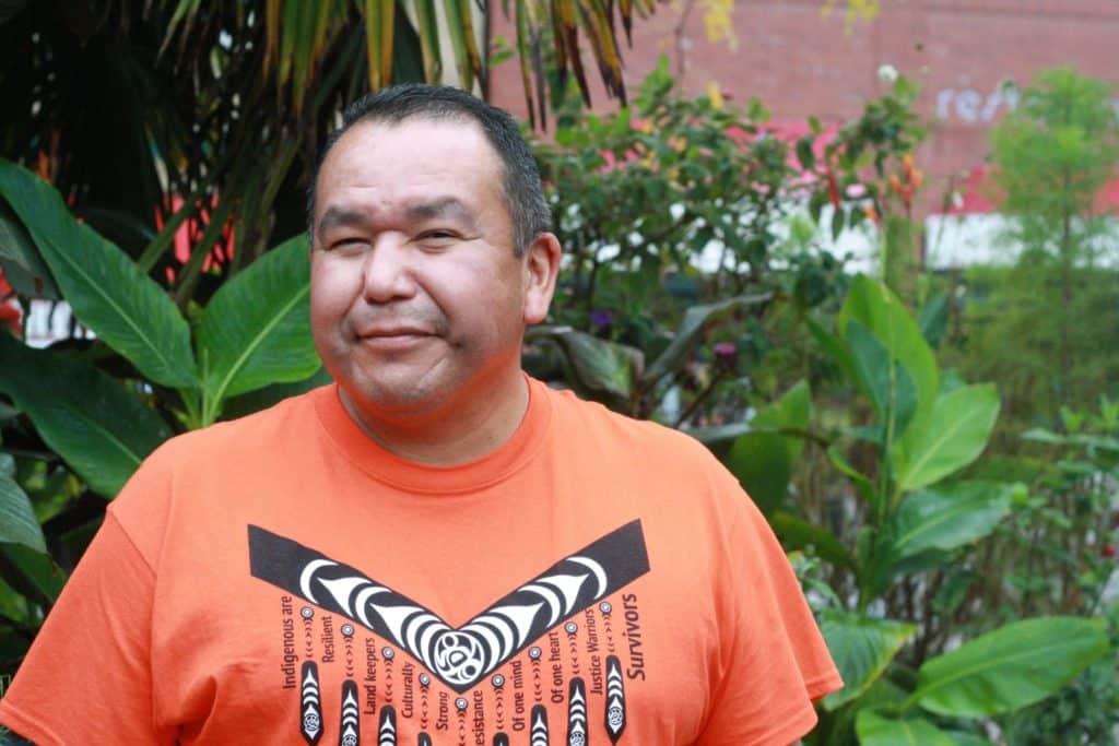Local activist, educator and Vancouver Island University student Kwinwahtala’Galis (Fred) Speck stands in front of the Vancouver Island University.