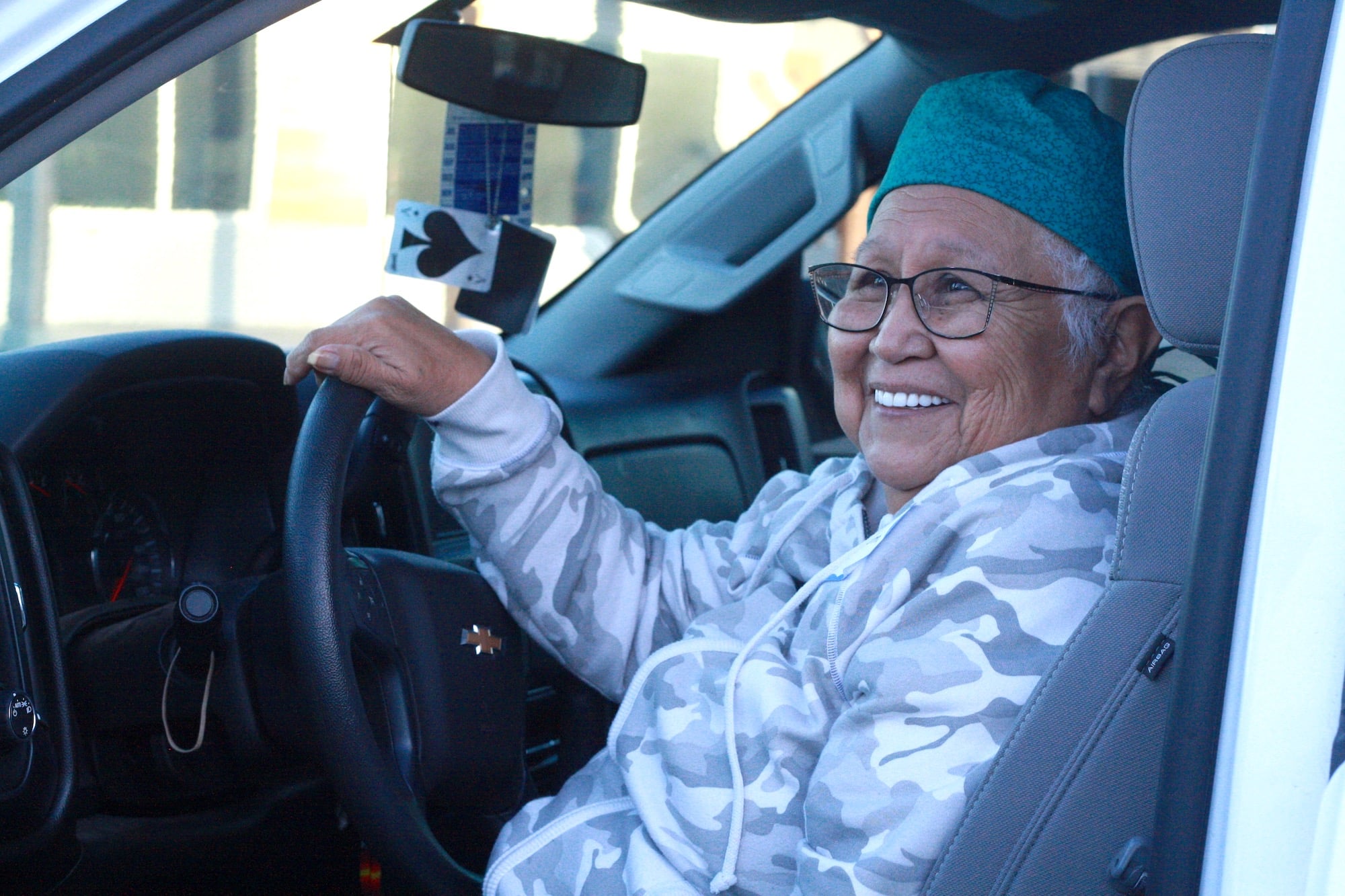 Elder ‘U’nihi-ya (Catherine) Jim sits in her truck as she speaks to journalist Julie Chadwick about the Elder literacy program.