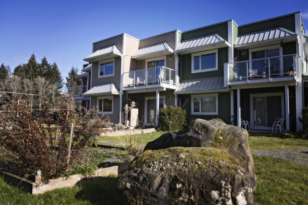 The units at the Pacific Gardens cohousing community look like a regular strata complex. But community areas like a big yard make it special.