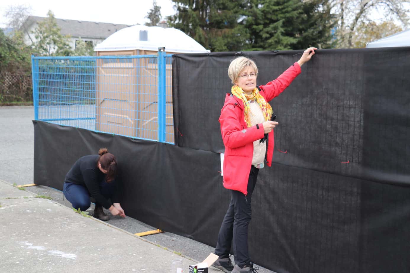 Debbie Berg CWAV installs privacy screens around the tenting site
