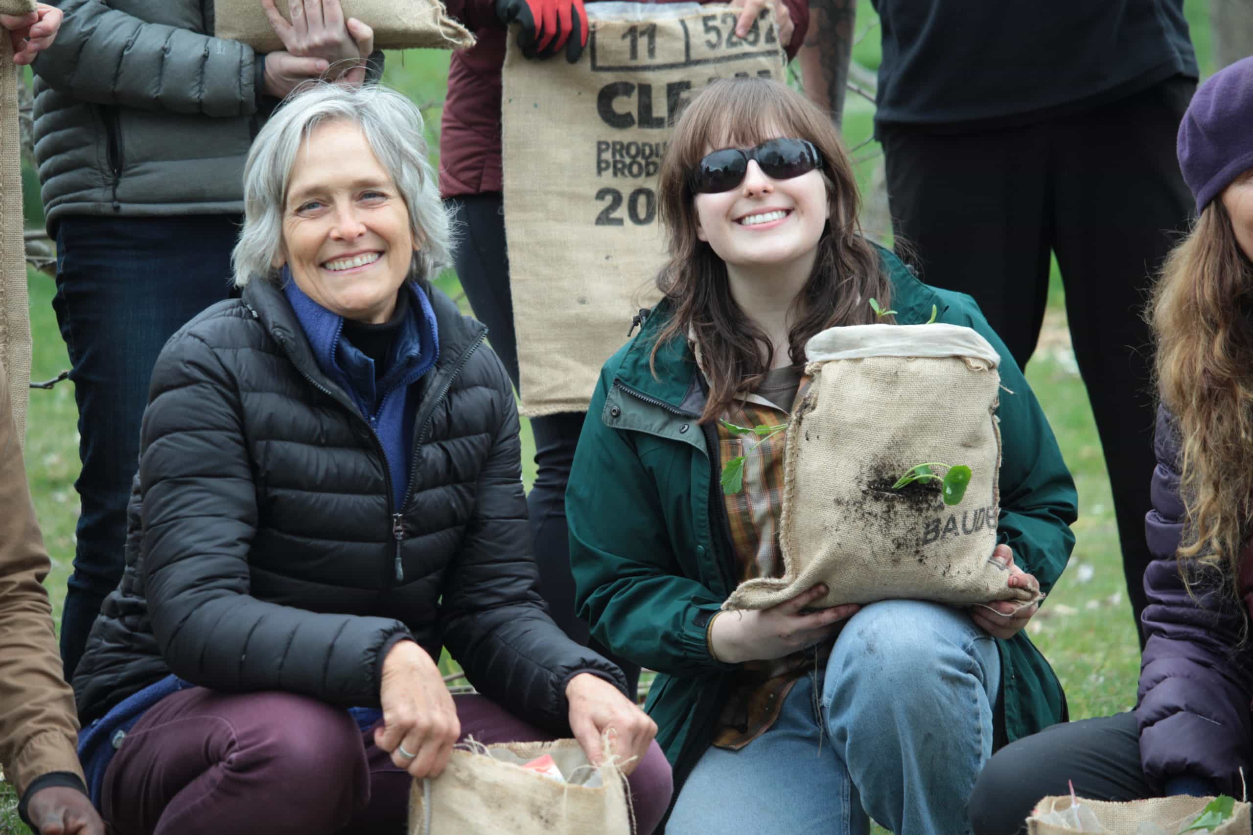 Valerie Legge and Lauren Ziffle pose with their mini burlap sack gardens.