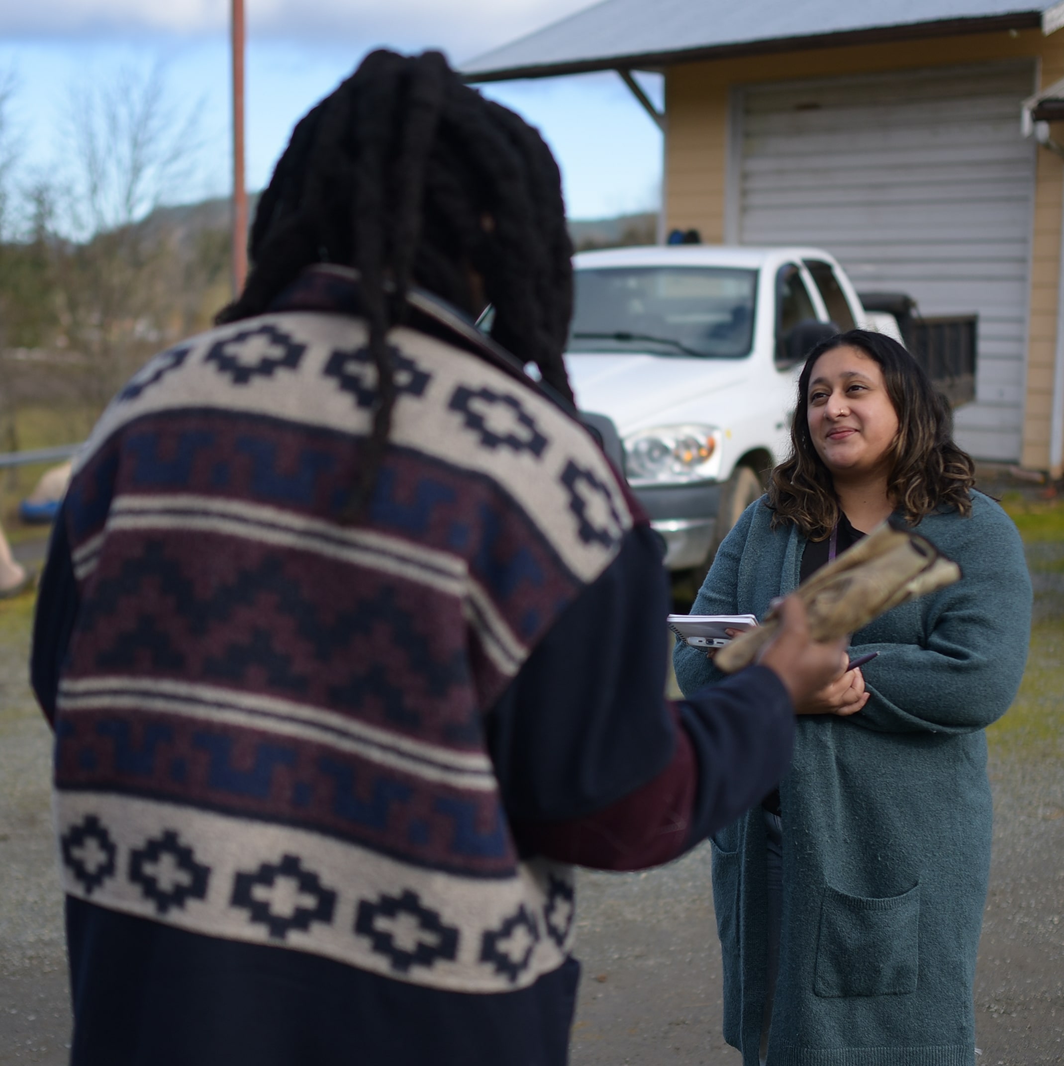 Shalu Mehta is pictured to the right of the photo interviewing Tafadzwa Matamba, who stands on the left with his back to the camera.