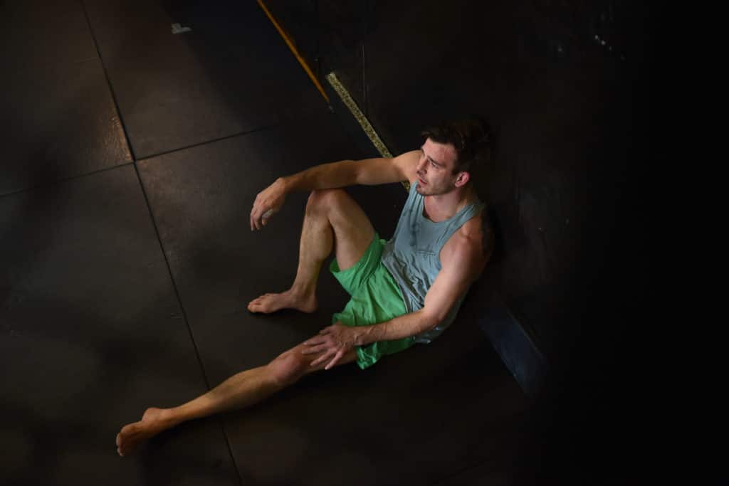 Shane Jung takes a break from training with a student at Black Box MMA