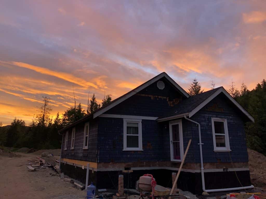 A rancher cottage sits on a new foundation in the morning light.