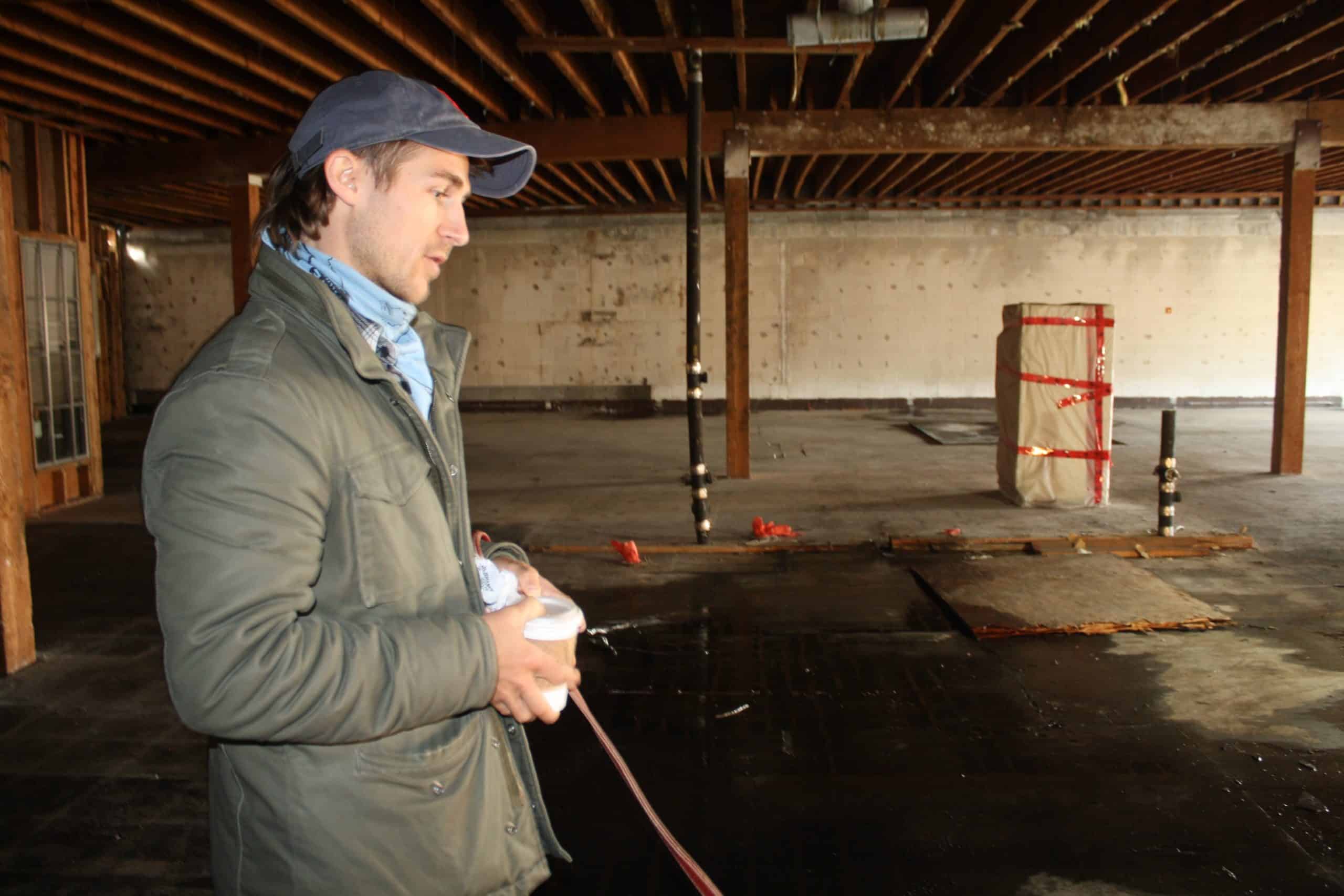 On the top floor of the building, concrete floors and soft lighting show a lot of potential for commercial spaces.