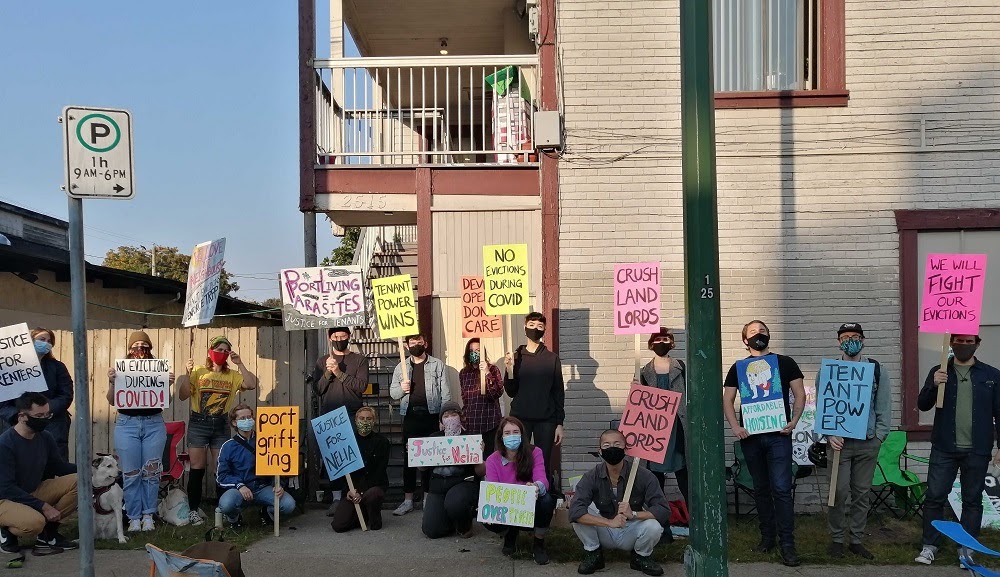 A dozen renters picket in front of a building in Vancouver holding signs in protest of an eviction.