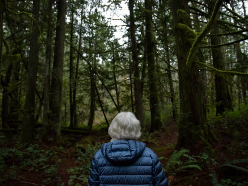 Vicky Husband, a recognized conservationist and southern Vancouver Island resident, looks out onto a parcel of forested land in the District of Highlands.