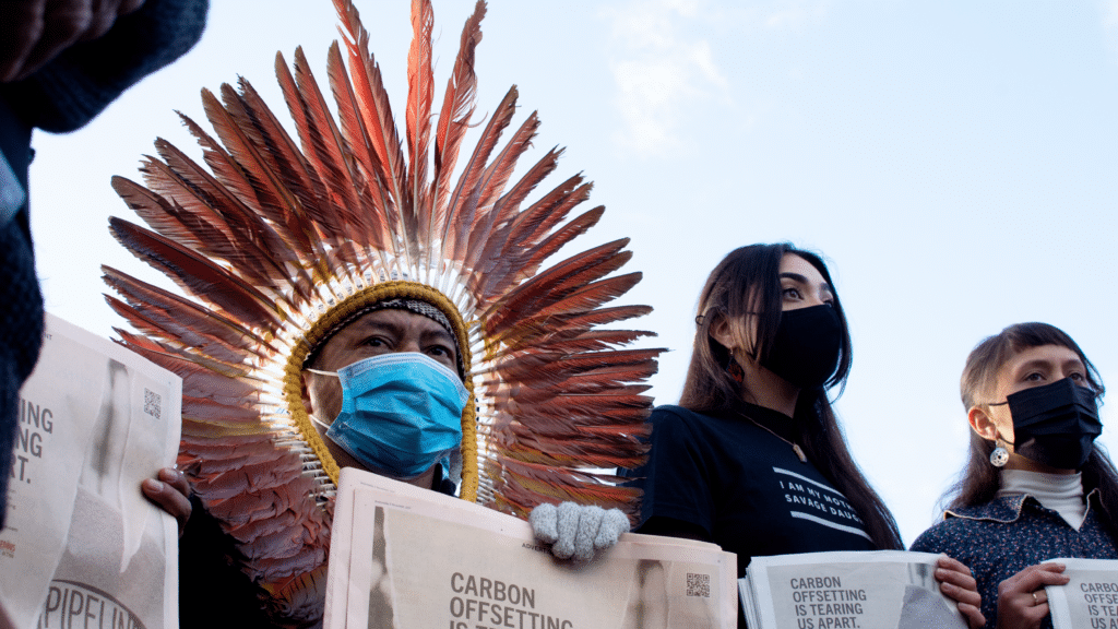 An action held outside the COP26 venue by the Indigenous Climate Action and Indigenous Environmental Network to protest carbon offsetting.