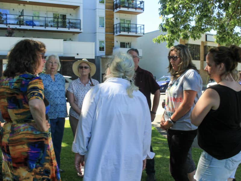 A group of seven people stand in a circle