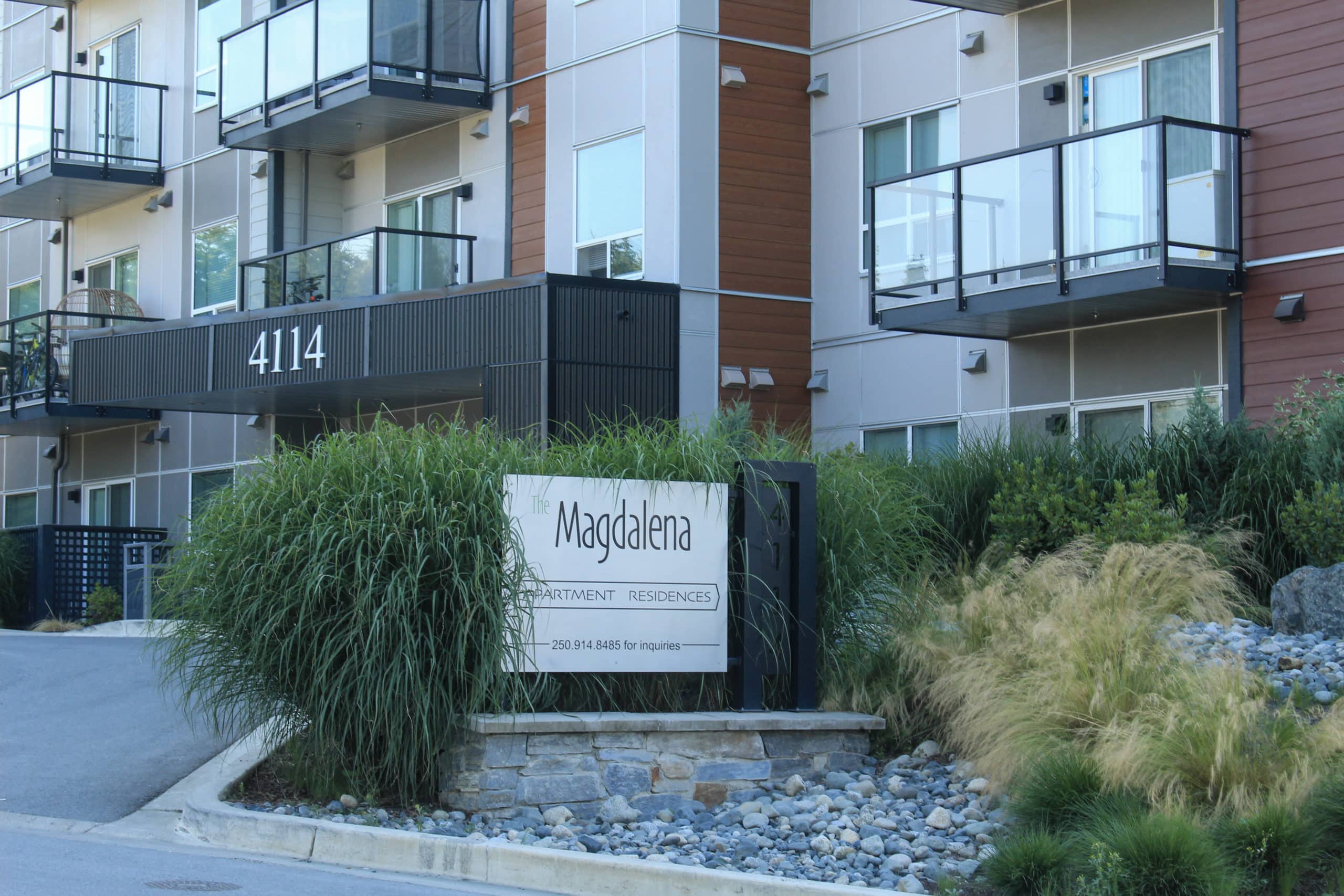 Front entrance of a North Cowichan apartment building with sign reading "Magdalena"