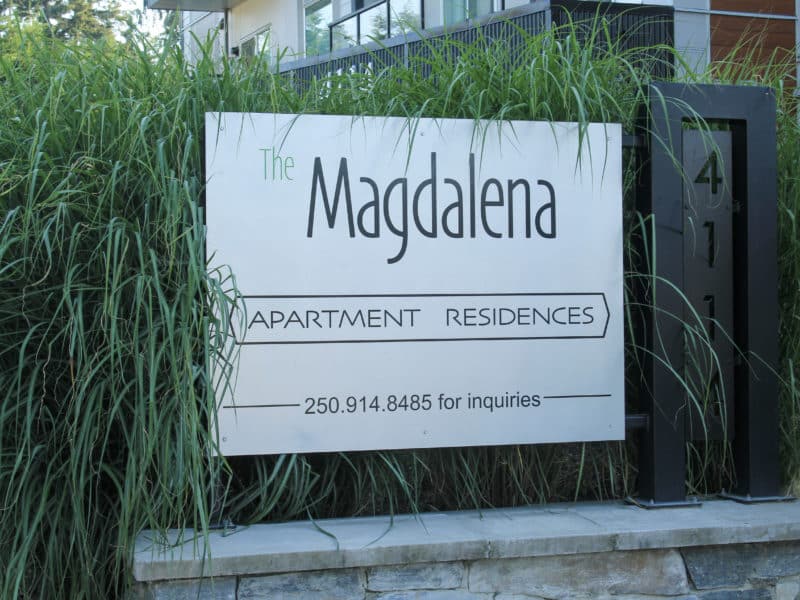 Sign outside building that says "Magdalena Apartment Residences"