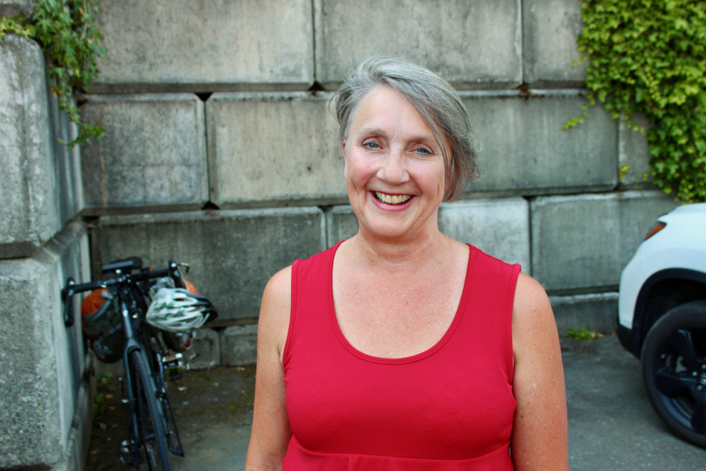 a woman in red with a big smile