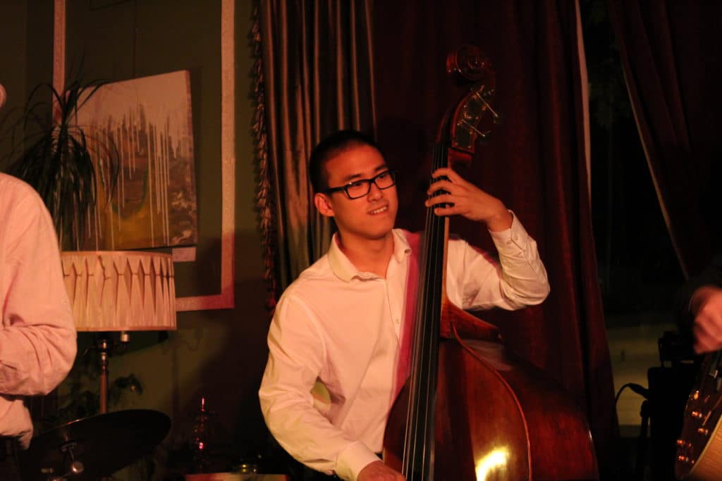 John Lee plays the bass at a Nanaimo venue on a dark stage.