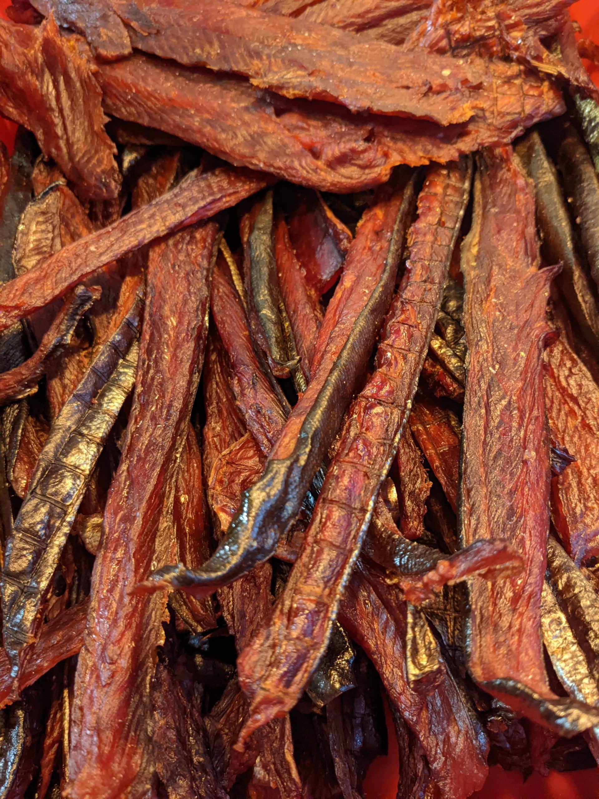 A pile of smoked salmon strips, orange in colour.