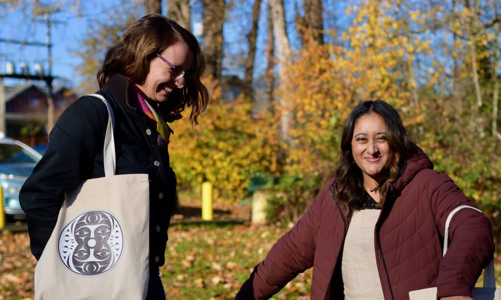 Two women laugh and dance