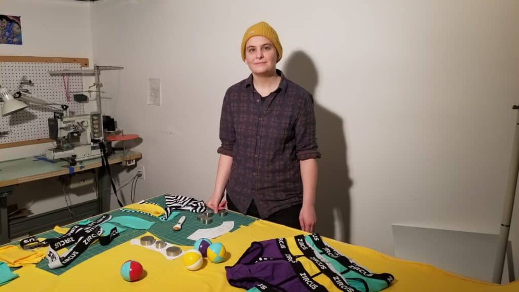Zircus designer and owner Al Murray in front of their textile table with completed briefs and juggling balls.