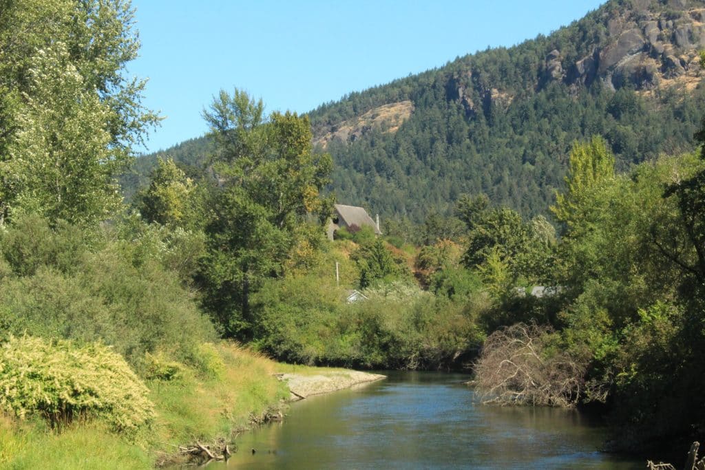 The Cowichan River is seen, with the Stone Church pictured in the background.