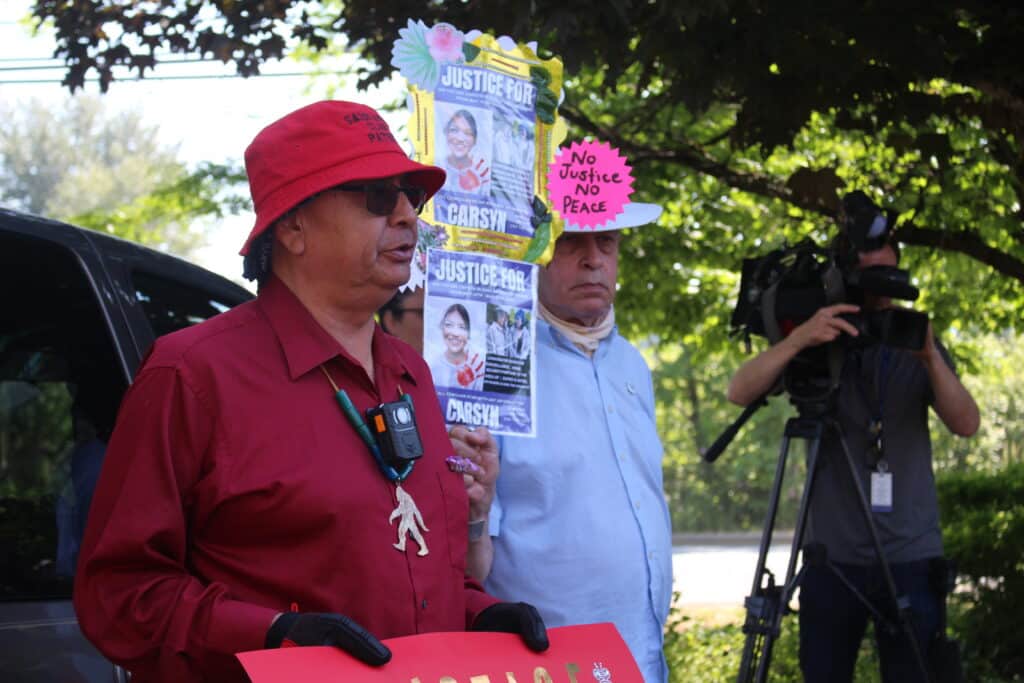 Two men holding signs