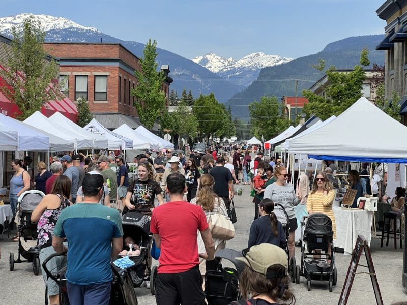 An outdoor marker with snow-capped mountains behind.