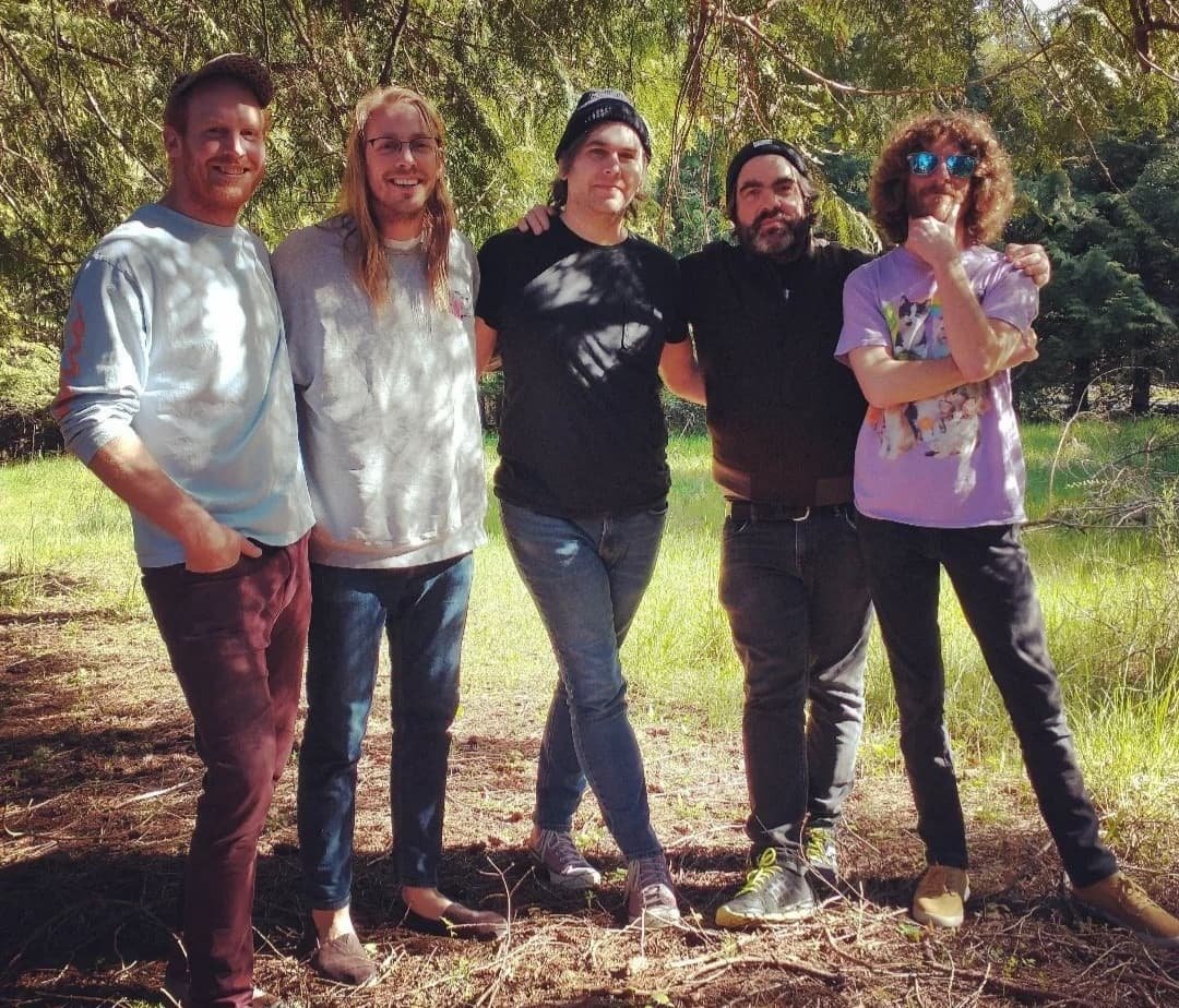 Colliding Canyons' Brendan Holm, Will Hills, Jordan Koop (of the Noise Floor recording studio), Arlen Thompson and Arlen Brown stand outside under a tree for a band photo last year.