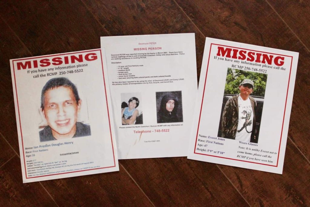 Three posters laid out on a table. They are missing posters for Desmond Peter, Ian Henry and Everett Jones.