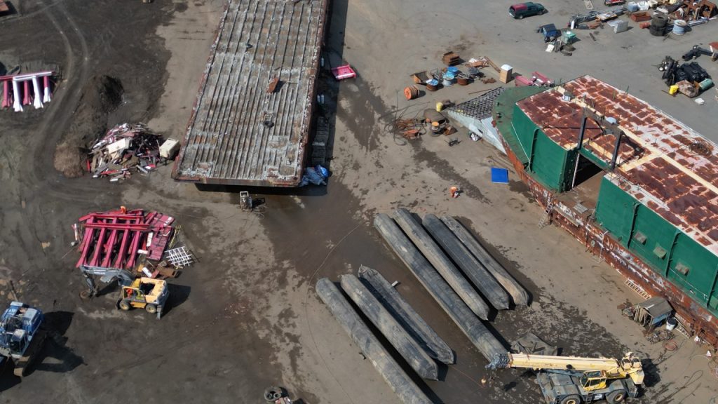 Scap metal and barges on a beach