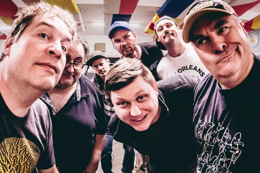 A group of men make faces into the camera