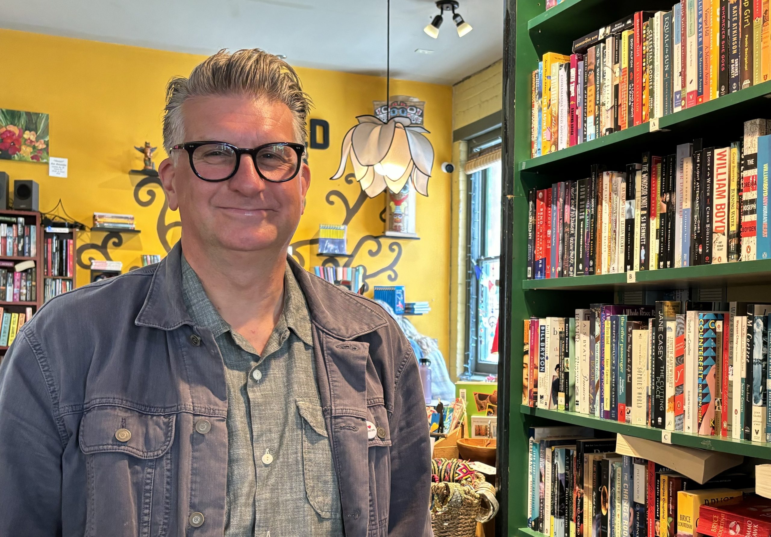 Jordan Kawchuk stands in front of some bookshelves at a bookstore in the Cowichan Valley.