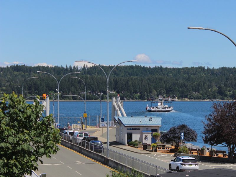 A small ferry is seen in transit between Buckley Bay and Danman Island on a sunny day