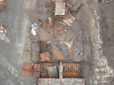 Rusty broken metal scraps from a barge broken up on a beach.