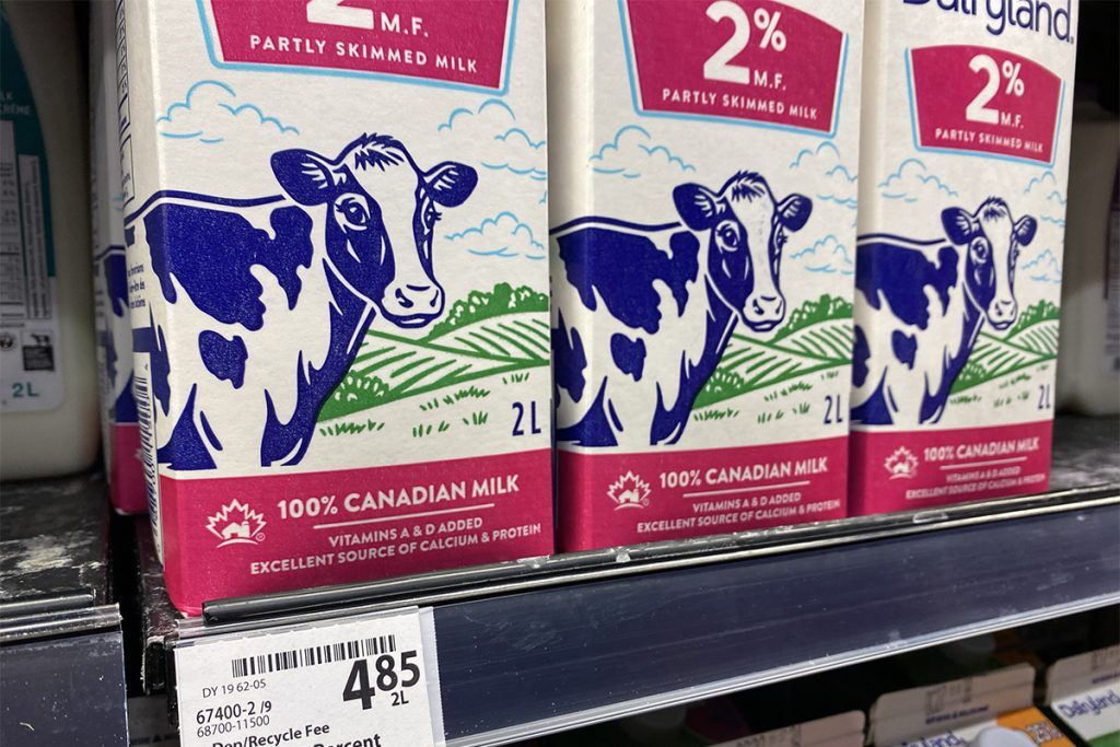 Photo of cartons of 2% Milk on a grocery shelf with the price of $4.85 for two litres.