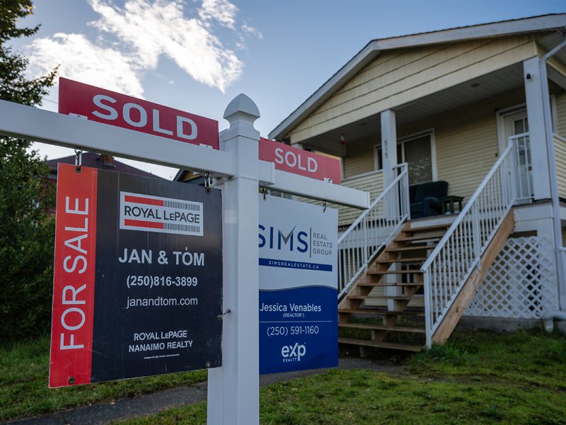 Housing Nanaimo. A photo of a single family house with a sold sign in the front yard.
