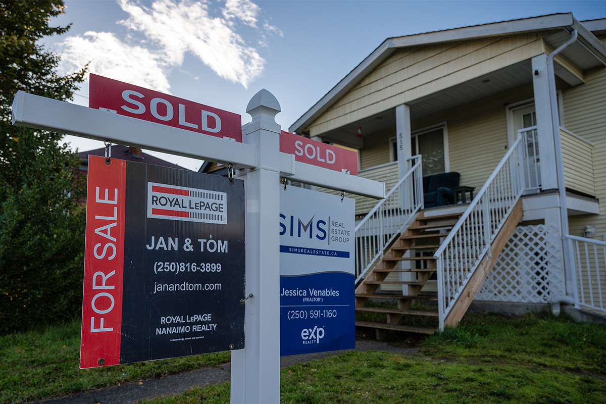 Housing Nanaimo. A photo of a single family house with a sold sign in the front yard.
