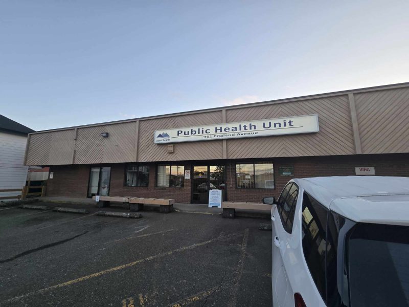 Outside of a building with a sign that says 'Options for Sexual Health.' It is around dusk.